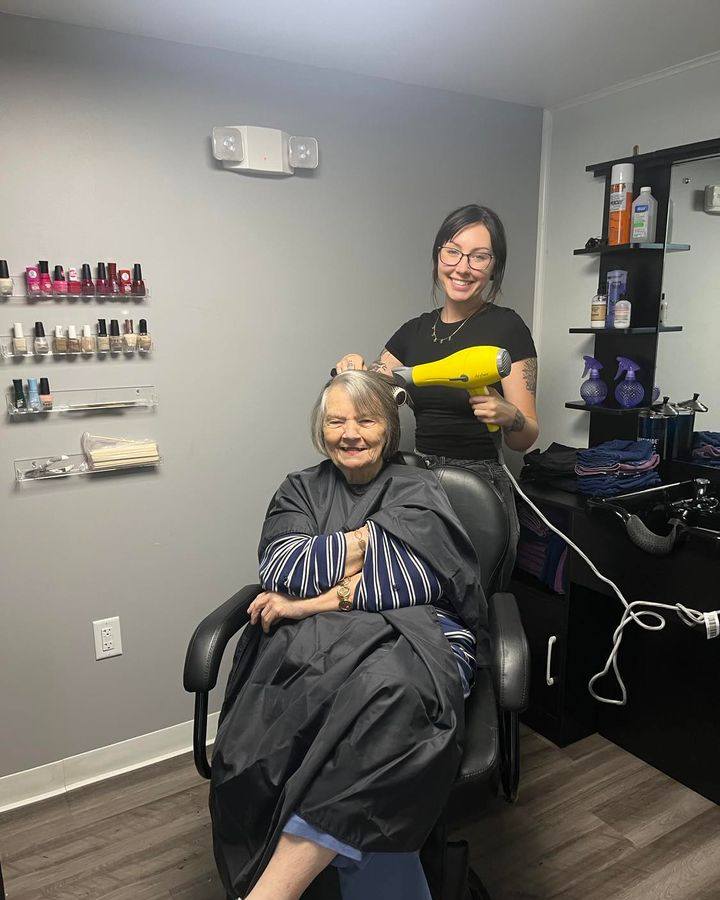 an older woman enjoying a hair service