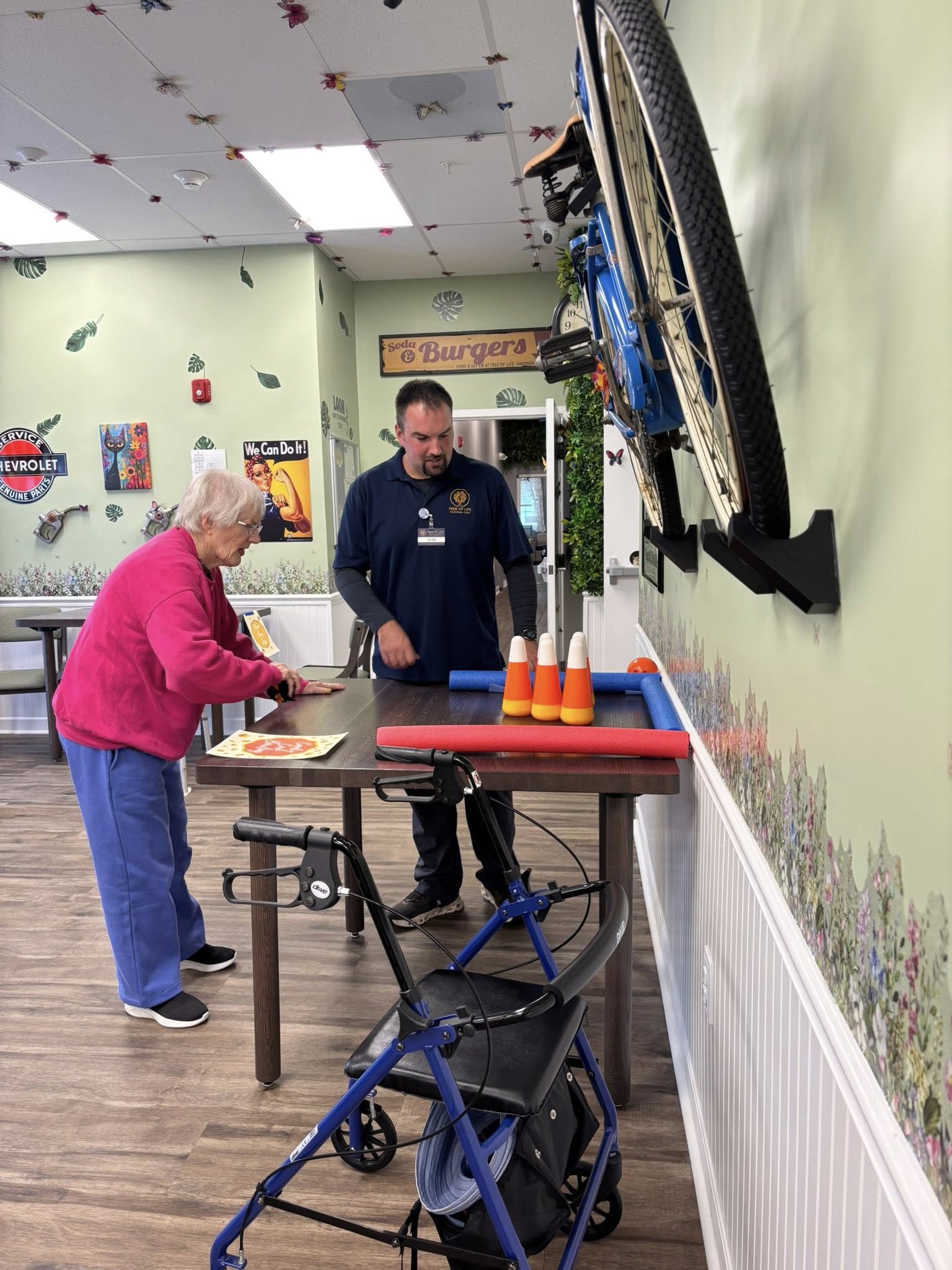 A staff member assisting a senior